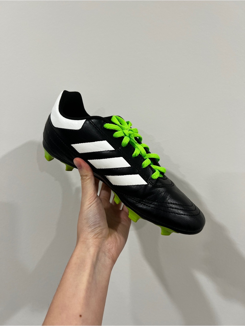 adidas Black Soccer Cleat with White Stripes and Neon Green Laces